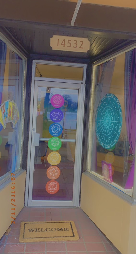 Entrance to Psychic Journey Spiritual Shoppe at 14532 Detroit Ave with chakra symbols on the door